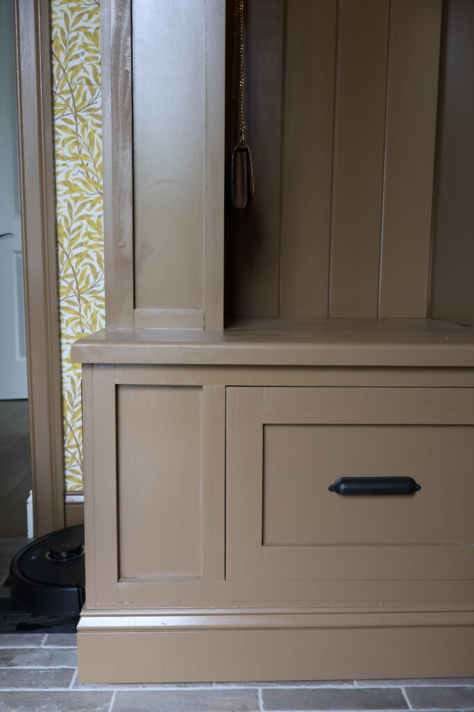 DIY mudroom makeover with custom floor-to-ceiling built-ins in Benjamin Moore Baked Pretzel, Morris and Co Willow Bough wallpaper in Summer Yellow, brick look porcelain tile floor.